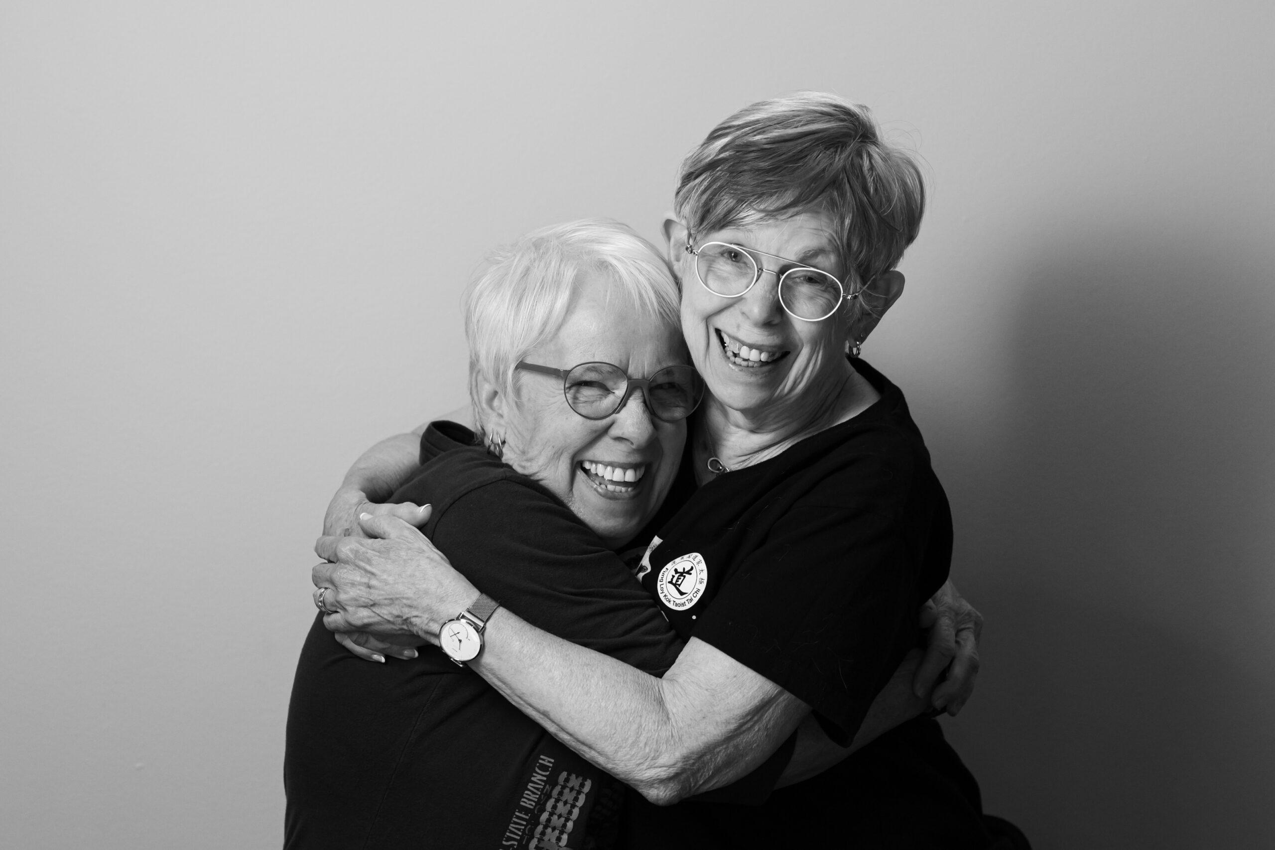 Black and white portrait of a Holladay Park Plaza couple happily embracing.