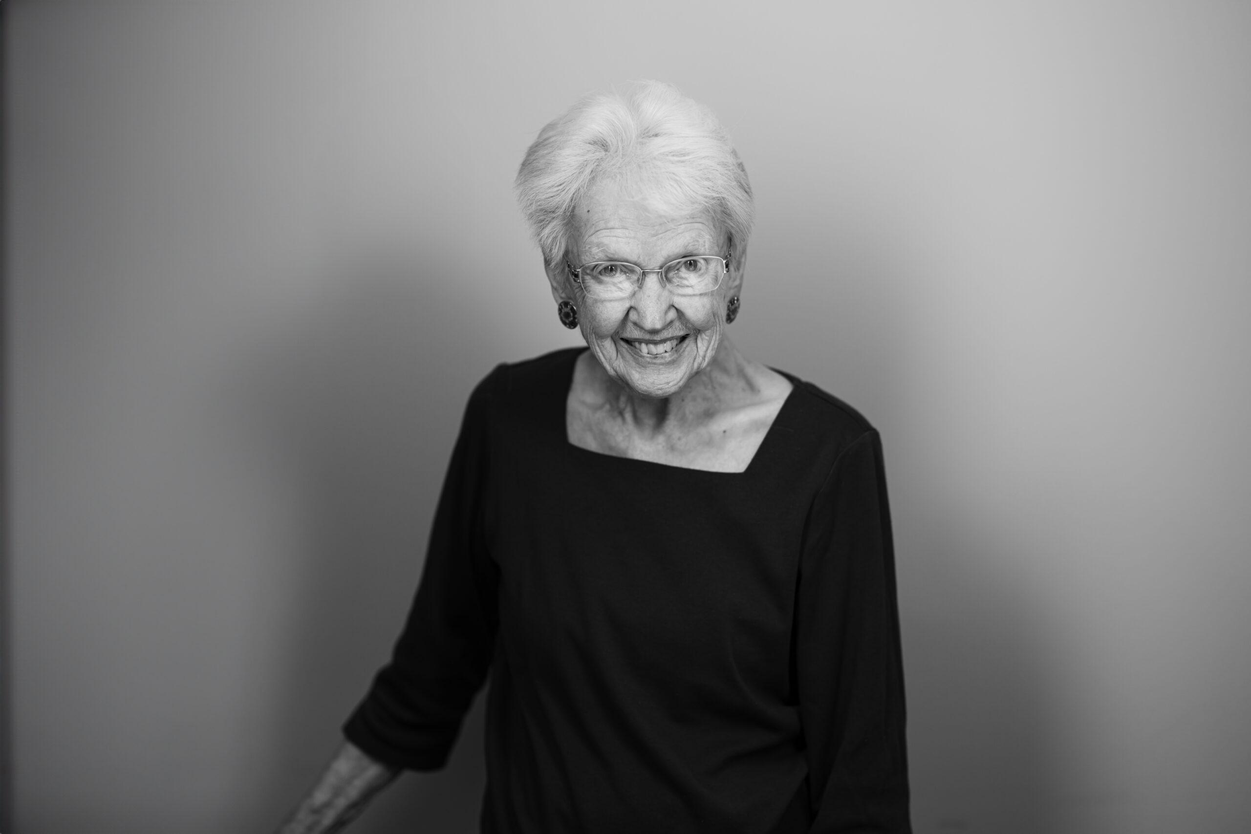 Black and white portrait of a Holladay Park Plaza resident smiling and looking at the camera.