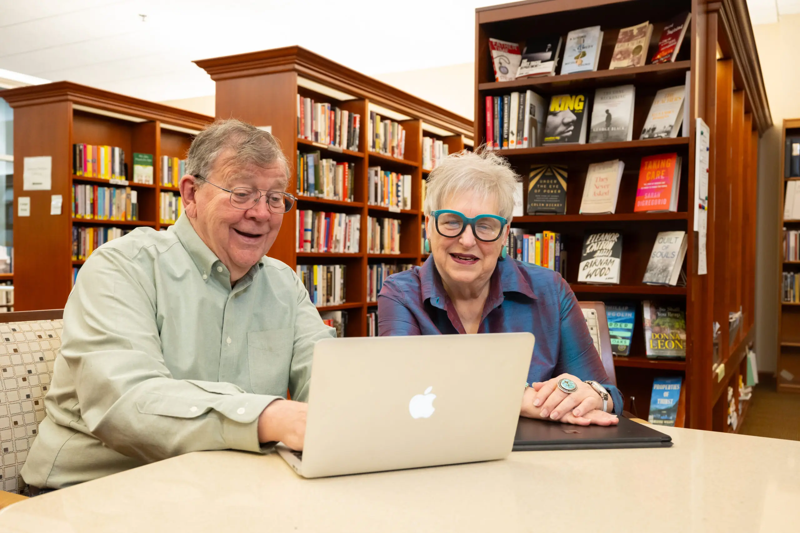 Holladay Park Plaza residents Ted and Punkin Schenck happily look at a computer in a library.